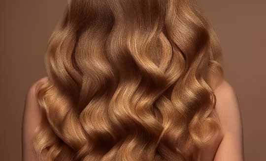 Long, honey-toned waves with a soft balayage finish