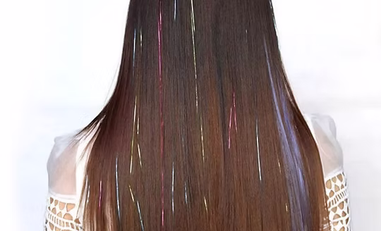 Fine, light-reflecting shimmer strands woven through long hair