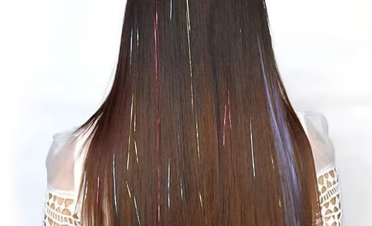 Fine, light-reflecting shimmer strands woven through long hair